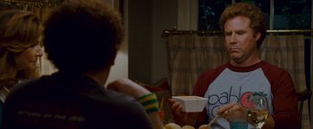 Movie still from “Step Brothers” (2008), directed by Adam McKay – A group of people sitting at a table eating food; Medium shot, Over the shoulder angle