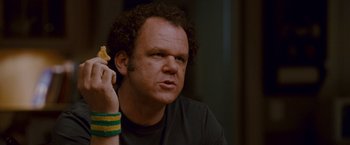 Movie still from “Step Brothers” (2008), directed by Adam McKay – A man holding a piece of food in front of his face; Close Up shot, Over the shoulder angle