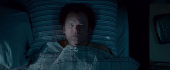 Movie still from “Step Brothers” (2008), directed by Adam McKay – A man laying in a bed under a blanket; Medium shot, Overhead angle