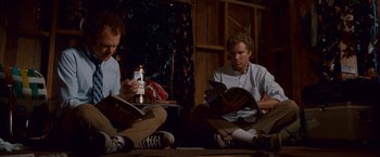 Movie still from “Step Brothers” (2008), directed by Adam McKay – Two men sitting on the ground reading books; Medium shot, High angle