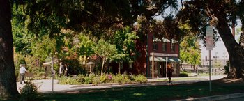 Movie still from “Step Brothers” (2008), directed by Adam McKay – A woman walking down the sidewalk in front of a building; Extreme Wide shot, High angle