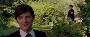 Movie still from “Step Brothers” (2008), directed by Adam McKay – A person wearing a suit and tie; Close Up shot, Over the shoulder angle