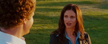 Movie still from “Step Brothers” (2008), directed by Adam McKay – A woman standing next to a man on a field; Close Up shot, Over the shoulder angle