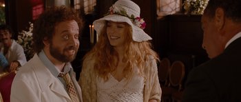 Movie still from “Barney's Version” (2010), directed by Richard J. Lewis – A woman wearing a white hat with flowers on it; Medium shot, Over the shoulder angle