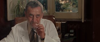 Movie still from “Barney's Version” (2010), directed by Richard J. Lewis – An older man sitting at a desk in a room; Close Up shot, Low angle