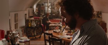 Movie still from “Barney's Version” (2010), directed by Richard J. Lewis – A man smoking a cigarette in front of a woman; Medium shot, Over the shoulder angle