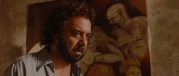 Movie still from “Barney's Version” (2010), directed by Richard J. Lewis – A man with a beard is looking into the distance; Close Up shot, Over the shoulder angle