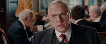 Movie still from “Barney's Version” (2010), directed by Richard J. Lewis – An older man wearing a suit and tie; Close Up shot, Over the shoulder angle