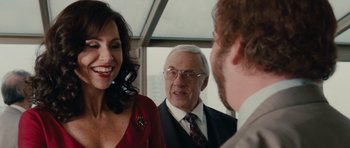 Movie still from “Barney's Version” (2010), directed by Richard J. Lewis – A man and a woman talking to a man in a suit; Close Up shot, Over the shoulder angle