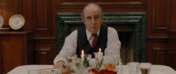 Movie still from “Barney's Version” (2010), directed by Richard J. Lewis – A man sitting at a dinner table with candles in front of him; Close Up shot, Over the shoulder angle