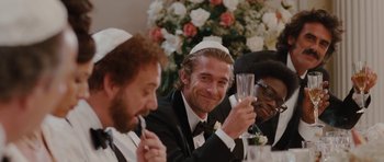 Movie still from “Barney's Version” (2010), directed by Richard J. Lewis – A group of men sitting at a table drinking champagne; Close Up shot, Over the shoulder angle