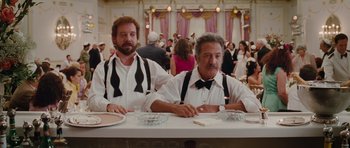 Movie still from “Barney's Version” (2010), directed by Richard J. Lewis – A couple of men sitting at a dinner table; Medium shot, Over the shoulder angle