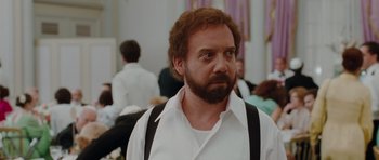Movie still from “Barney's Version” (2010), directed by Richard J. Lewis – A man with a beard wearing a white shirt and black suspenders; Close Up shot, Over the shoulder angle