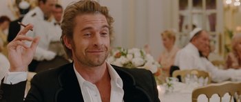 Movie still from “Barney's Version” (2010), directed by Richard J. Lewis – A person sitting in a room; Close Up shot, Over the shoulder angle