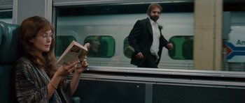 Movie still from “Barney's Version” (2010), directed by Richard J. Lewis – A man in a tuxedo is walking on a train; Medium shot, Over the shoulder angle