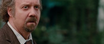 Movie still from “Barney's Version” (2010), directed by Richard J. Lewis – A person wearing a suit and tie; Close Up shot, Over the shoulder angle