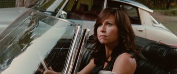Movie still from “Barney's Version” (2010), directed by Richard J. Lewis – A woman sitting in front of a white car; Close Up shot, Over the shoulder angle