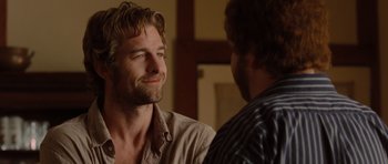 Movie still from “Barney's Version” (2010), directed by Richard J. Lewis – Two men talking to each other in front of a wall; Close Up shot, Over the shoulder angle