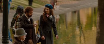 A man and a woman walking next to a body of water