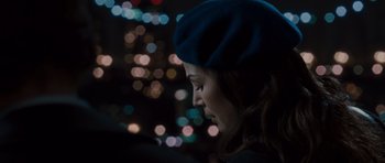 Movie still from “Barney's Version” (2010), directed by Richard J. Lewis – A woman wearing a blue hat looking down at the ground; Close Up shot, Over the shoulder angle