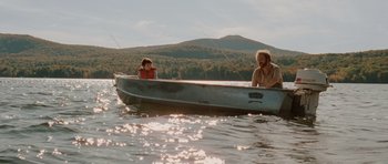 Movie still from “Barney's Version” (2010), directed by Richard J. Lewis – A man and a boy in a boat on a lake; Wide shot, Low angle