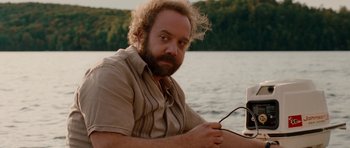 Movie still from “Barney's Version” (2010), directed by Richard J. Lewis – A man sitting on a boat in the middle of a lake; Medium shot, Over the shoulder angle