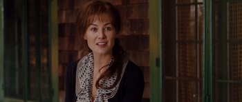 Movie still from “Barney's Version” (2010), directed by Richard J. Lewis – A woman wearing a black jacket and a scarf smiling; Close Up shot, Over the shoulder angle