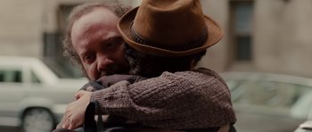 Movie still from “Barney's Version” (2010), directed by Richard J. Lewis – A man wearing a hat hugging another man in a sweater; Close Up shot, Over the shoulder angle