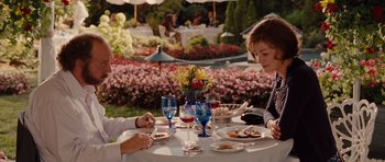 Movie still from “Barney's Version” (2010), directed by Richard J. Lewis – Two people are sitting at a table with food and wine; Medium shot, Over the shoulder angle