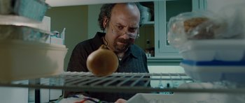 Movie still from “Barney's Version” (2010), directed by Richard J. Lewis – An older man looking at an onion in an oven; Close Up shot, Over the shoulder angle