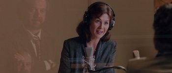 Movie still from “Barney's Version” (2010), directed by Richard J. Lewis – A woman wearing headphones and a microphone in front of a microphone stand; Close Up shot, Over the shoulder angle