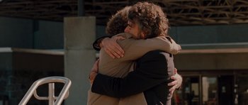 Movie still from “Barney's Version” (2010), directed by Richard J. Lewis – Two people hugging each other in the street; Close Up shot, Over the shoulder angle