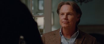 Movie still from “Barney's Version” (2010), directed by Richard J. Lewis – A person wearing a suit and tie; Close Up shot, Over the shoulder angle