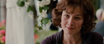 Movie still from “Barney's Version” (2010), directed by Richard J. Lewis – A woman's face in front of some flowers; Close Up shot, Over the shoulder angle