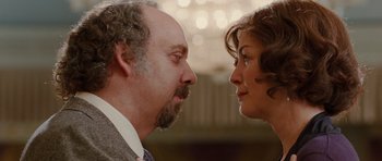Movie still from “Barney's Version” (2010), directed by Richard J. Lewis – A man and a woman face to face in front of lights; Close Up shot, Over the shoulder angle