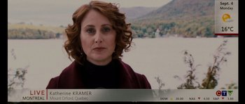 Movie still from “Barney's Version” (2010), directed by Richard J. Lewis – A person wearing a jacket near a body of water; Close Up shot, Over the shoulder angle