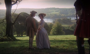 Movie still from “Barry Lyndon” (1975), directed by Stanley Kubrick – A man and a woman standing on top of a grass covered hill; Wide shot, High angle