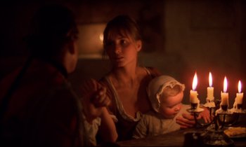 Movie still from “Barry Lyndon” (1975), directed by Stanley Kubrick – A man and a woman sitting in front of a lit candle; Medium shot, Over the shoulder angle
