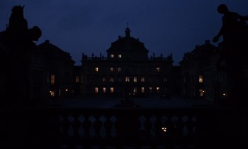 Movie still from “Barry Lyndon” (1975), directed by Stanley Kubrick – A large building with lights on top of it at night time; Extreme Wide shot, Low angle