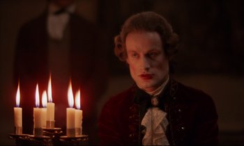 Movie still from “Barry Lyndon” (1975), directed by Stanley Kubrick – A man in a red and black jacket with candles; Close Up shot, Over the shoulder angle