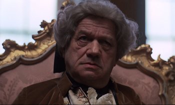 Movie still from “Barry Lyndon” (1975), directed by Stanley Kubrick – An older man in a wig and a jacket; Close Up shot, Low angle