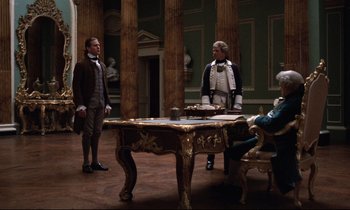 Movie still from “Barry Lyndon” (1975), directed by Stanley Kubrick – Two men dressed in period clothing standing in front of a table; Wide shot, Low angle
