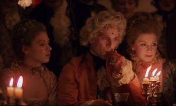 Movie still from “Barry Lyndon” (1975), directed by Stanley Kubrick – A group of people sitting around a table; Medium shot, Low angle