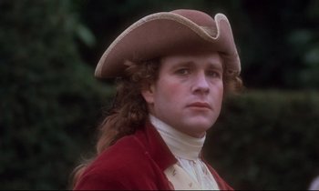 Movie still from “Barry Lyndon” (1975), directed by Stanley Kubrick – A man wearing a red jacket and a brown hat; Close Up shot, Over the shoulder angle