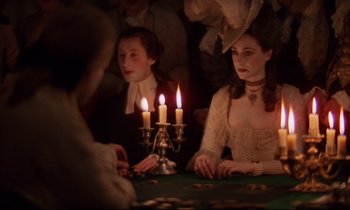 Movie still from “Barry Lyndon” (1975), directed by Stanley Kubrick – A group of people sitting around a table with candles; Medium shot, Over the shoulder angle
