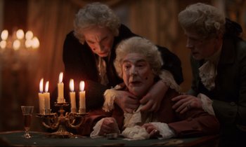 Movie still from “Barry Lyndon” (1975), directed by Stanley Kubrick – A group of people that are sitting around a table; Medium shot, High angle