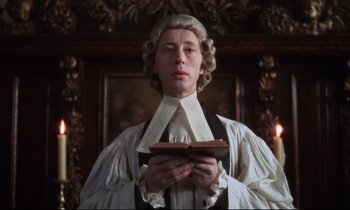 Movie still from “Barry Lyndon” (1975), directed by Stanley Kubrick – A man in a wig holding an open book in front of a painting; Close Up shot, Low angle