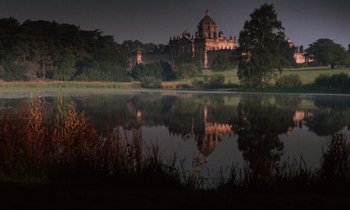 Movie still from “Barry Lyndon” (1975), directed by Stanley Kubrick – A lake with trees and a building in the background at night time; Extreme Wide shot, High angle