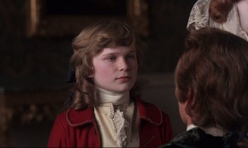 Movie still from “Barry Lyndon” (1975), directed by Stanley Kubrick – A young girl wearing a red jacket and a white shirt; Close Up shot, Over the shoulder angle