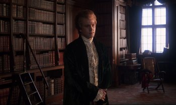 Movie still from “Barry Lyndon” (1975), directed by Stanley Kubrick – A man standing in front of a book shelf; Medium shot, Over the shoulder angle